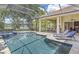 Luxurious screened-in pool area with spa, outdoor seating, and views of the lake at 9818 Tree Tops Lake Rd, Tampa, FL 33626