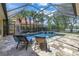 Stunning screened pool with a spa and a relaxing lounge area, perfect for enjoying sunny days at 9818 Tree Tops Lake Rd, Tampa, FL 33626