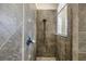 Close-up of tiled shower with bronze shower head and tiled surround at 9818 Tree Tops Lake Rd, Tampa, FL 33626