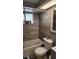 Modern bathroom featuring a tiled tub and shower, plus a window for natural light at 9926 Gray Fox Ln, Port Richey, FL 34668
