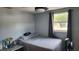 This bedroom features natural light, and grey walls at 9926 Gray Fox Ln, Port Richey, FL 34668