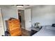 This bedroom features wood-look flooring, a dresser, and a ceiling fan at 9926 Gray Fox Ln, Port Richey, FL 34668