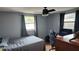 This bedroom features natural light, a ceiling fan, and wood-look flooring at 9926 Gray Fox Ln, Port Richey, FL 34668