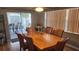 Inviting dining room leading to patio with wood table set, ample lighting, and stylish decor at 9926 Gray Fox Ln, Port Richey, FL 34668
