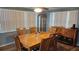 A charming dining room with wood floors and matching furniture at 9926 Gray Fox Ln, Port Richey, FL 34668
