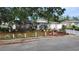 Charming single-story home with attached garage and beautifully landscaped front yard and lush trees at 9926 Gray Fox Ln, Port Richey, FL 34668