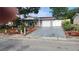 Charming single-story home with attached garage, driveway, and beautifully landscaped front yard at 9926 Gray Fox Ln, Port Richey, FL 34668