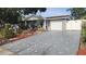 Charming single-story home with attached garage, driveway, and beautifully landscaped front yard at 9926 Gray Fox Ln, Port Richey, FL 34668