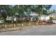 Charming single-story home with mature trees and a well-maintained front yard with decorations at 9926 Gray Fox Ln, Port Richey, FL 34668