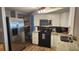 Bright kitchen with stainless steel refrigerator and microwave and updated counter tops at 9926 Gray Fox Ln, Port Richey, FL 34668