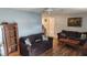 Cozy living room with comfortable sofas, wood floors, and decorative artwork at 9926 Gray Fox Ln, Port Richey, FL 34668