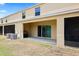 Backyard area features a covered patio, sliding glass doors, and mature landscaping at 9960 Hound Chase Dr, Gibsonton, FL 33534