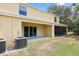 Backyard area featuring a covered patio and screened-in patio, with sliding glass doors at 9960 Hound Chase Dr, Gibsonton, FL 33534