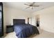 Well-lit bedroom with a ceiling fan, neutral colors, and a view of a walk-in closet at 9960 Hound Chase Dr, Gibsonton, FL 33534