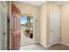 Inviting foyer with neutral walls and tile flooring, showcasing an open entryway and natural light at 9960 Hound Chase Dr, Gibsonton, FL 33534