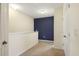 A second story hallway with carpet, painted accent wall, and a storage closet at 9960 Hound Chase Dr, Gibsonton, FL 33534