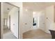 Hallway featuring neutral colored walls, carpet flooring, and access to multiple rooms at 9960 Hound Chase Dr, Gibsonton, FL 33534