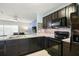 Modern kitchen featuring stainless steel appliances, granite countertops, and mosaic backsplash at 9960 Hound Chase Dr, Gibsonton, FL 33534