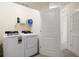 Convenient laundry room featuring a washer, dryer, and storage shelves at 9960 Hound Chase Dr, Gibsonton, FL 33534