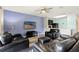 Stylish living room with wood-look floors, a ceiling fan, and a TV, adjacent to the kitchen at 9960 Hound Chase Dr, Gibsonton, FL 33534