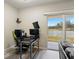 Office space with modern desk setup and sliding glass doors leading to outdoor area at 9960 Hound Chase Dr, Gibsonton, FL 33534