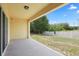 View of back patio featuring ceiling light, and view of back yard with fence at 9960 Hound Chase Dr, Gibsonton, FL 33534