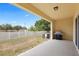 Covered patio area with a ceiling light, barbecue grill, and view of the backyard at 9960 Hound Chase Dr, Gibsonton, FL 33534