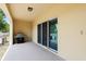 Covered back patio area with sliding glass doors, grill, and AC at 9960 Hound Chase Dr, Gibsonton, FL 33534