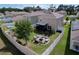 Aerial view of a spacious backyard with a fire pit, seating, manicured landscaping, and a white fence at 11013 Leland Groves Dr, Riverview, FL 33579
