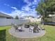 Backyard fire pit with Adirondack chairs and bench seating at 11013 Leland Groves Dr, Riverview, FL 33579
