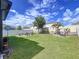 Spacious backyard featuring a cozy seating area and swing, perfect for relaxation and outdoor entertainment at 11013 Leland Groves Dr, Riverview, FL 33579