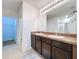 Spacious bathroom features double sinks and granite countertops, complemented by access to a walk-in closet and shower at 11013 Leland Groves Dr, Riverview, FL 33579