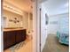 Bathroom featuring double sinks, a well-lit mirror, and access to a bright bedroom with a mounted TV at 11013 Leland Groves Dr, Riverview, FL 33579