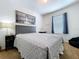 Bright bedroom with a gray headboard, a cozy comforter, and a large window, offering a comfortable and inviting space at 11013 Leland Groves Dr, Riverview, FL 33579