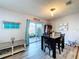 Bright dining area with wood-look flooring, sliding glass doors to the patio, and a modern light fixture at 11013 Leland Groves Dr, Riverview, FL 33579