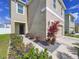 Two-story home with manicured landscaping, a two-car garage, and a welcoming entrance at 11013 Leland Groves Dr, Riverview, FL 33579