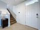 Bright foyer featuring a staircase, neutral tile flooring, and a white front door at 11013 Leland Groves Dr, Riverview, FL 33579