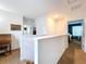 Upstairs hallway showcasing neutral walls, carpet flooring, and doorways leading to bedrooms, enhancing the home's spacious feel at 11013 Leland Groves Dr, Riverview, FL 33579
