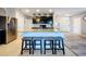 Spacious kitchen island with granite countertops, seating, and a sink, perfect for meal preparation and casual dining at 11013 Leland Groves Dr, Riverview, FL 33579