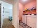 Laundry room with modern appliances and shelving, conveniently located near a bedroom at 11013 Leland Groves Dr, Riverview, FL 33579