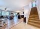 Open-concept layout with living room, kitchen, and staircase, perfect for entertaining at 11013 Leland Groves Dr, Riverview, FL 33579