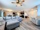 Open-concept living room with hardwood floors, comfortable seating, and a view of the dining area at 11013 Leland Groves Dr, Riverview, FL 33579