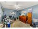 Bedroom with blue walls, neutral carpet, ceiling fan and view of the backyard at 11200 102Nd Ave # 75, Seminole, FL 33778