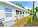 Side view of the condo showing the light blue exterior, windows and grass yard at 11200 102Nd Ave # 75, Seminole, FL 33778