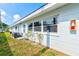 Side view of the condo showing the light blue exterior, windows, grass yard, and AC unit at 11200 102Nd Ave # 75, Seminole, FL 33778