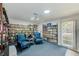 Cozy library featuring a wall of books, comfortable chairs, and natural light from the window at 11200 102Nd Ave # 75, Seminole, FL 33778