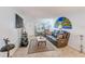 Spacious living room with tile floors, comfortable seating, and a large screen TV at 11200 102Nd Ave # 75, Seminole, FL 33778