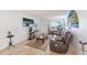 Cozy living room featuring tile floors, comfortable seating, and a large television at 11200 102Nd Ave # 75, Seminole, FL 33778