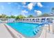 Community pool and adjacent structure in the background against blue skies at 11200 102Nd Ave # 75, Seminole, FL 33778
