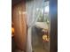 Cozy balcony with seating, offering a relaxing outdoor space and nice views, as seen through sheer, decorative curtains at 11201 122Nd Ave # 129, Largo, FL 33778